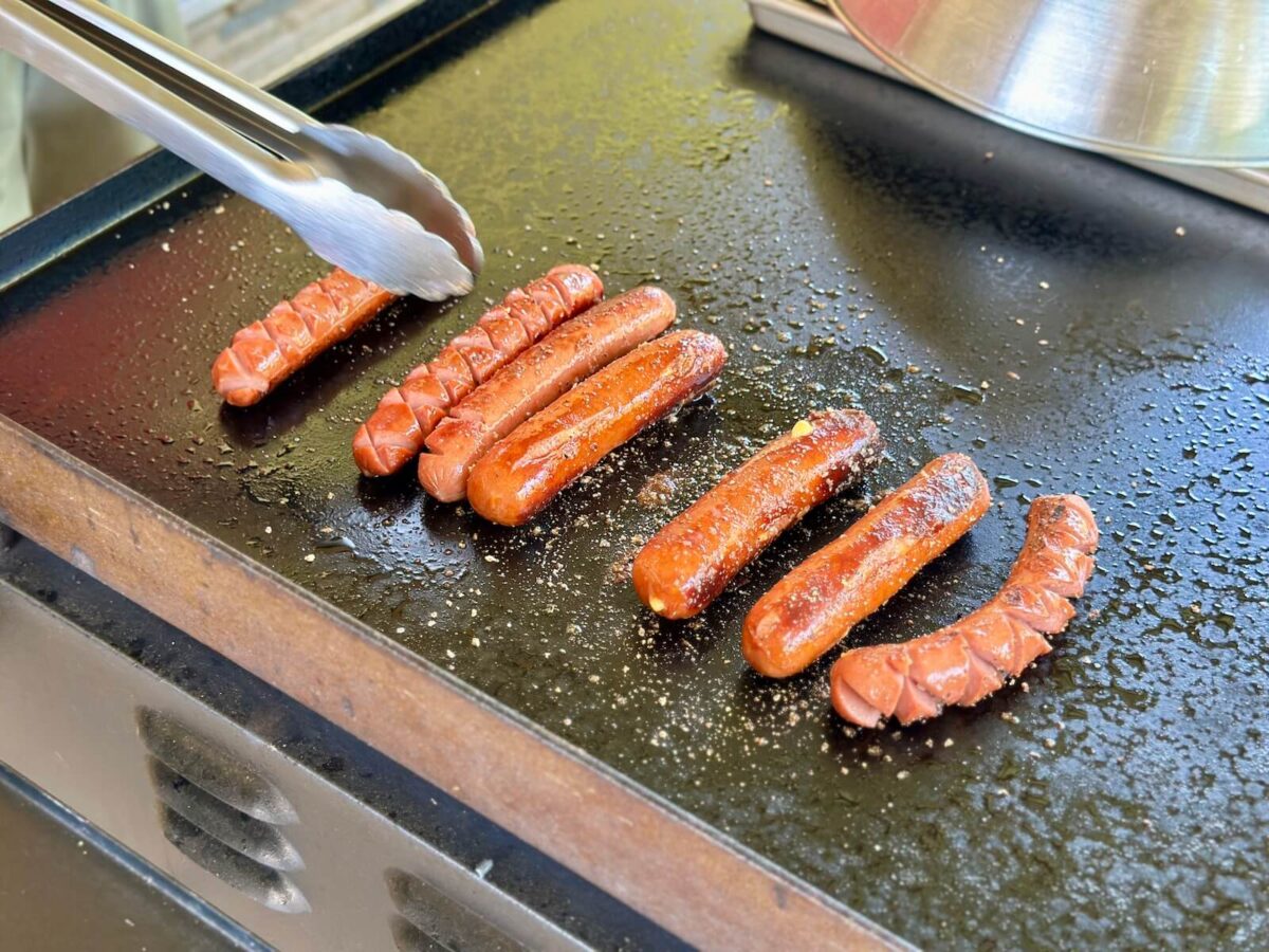 cooking hot dogs on a Blackstone