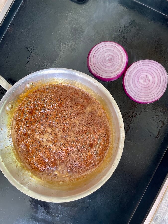 reducing homemade teriyaki sauce in a skillet