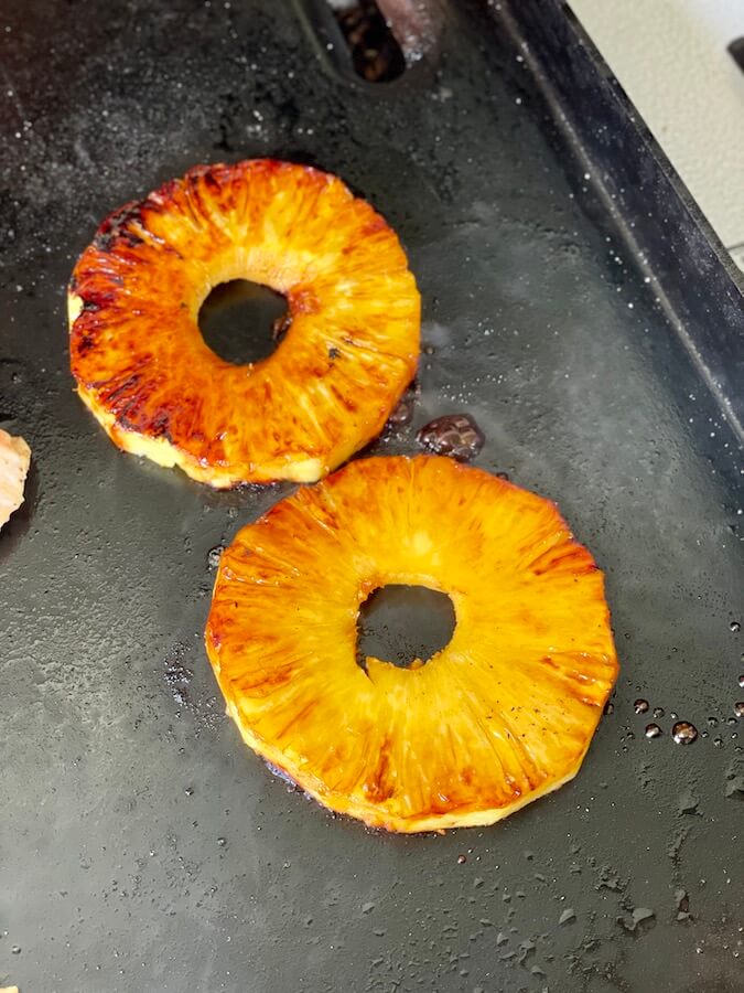 grilling pineapple slices on the griddle
