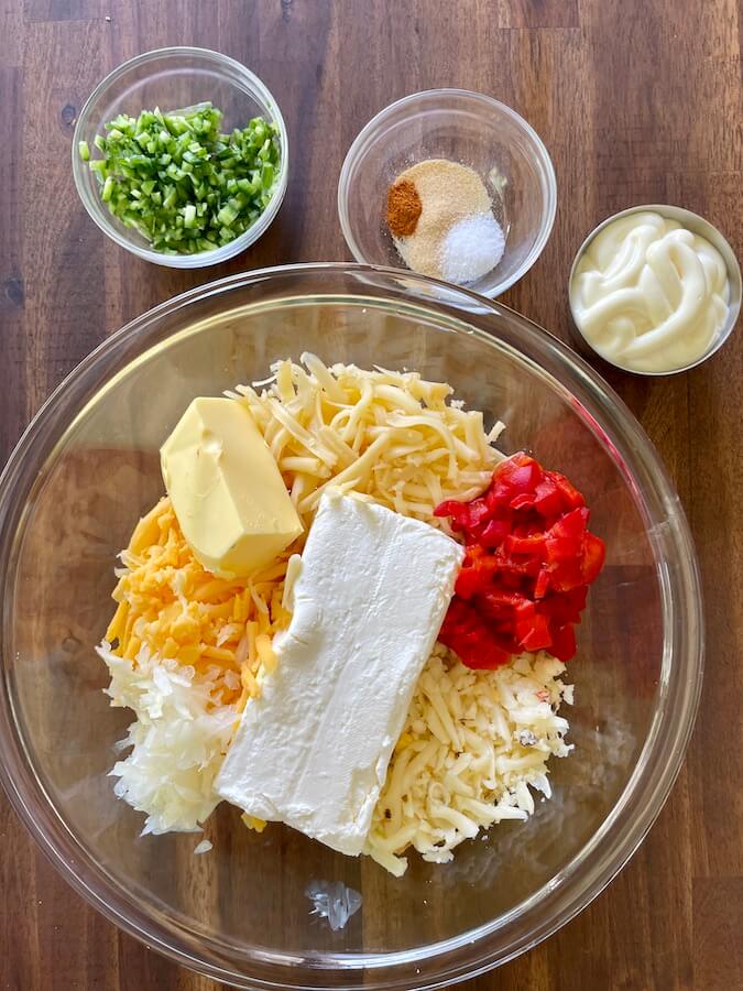 shredded cheese, diced pimentos, cream cheese, jalapenos, butter, and mayonnaise in a bowl