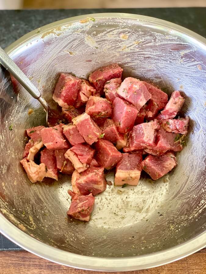 marinating steak bites in a bowl