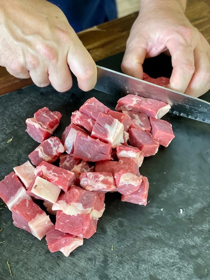 cutting steak into cubes