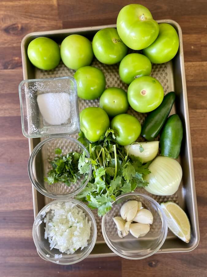 tomatillos, jalapenos, onion, garlic, cilantro, limes, and salt