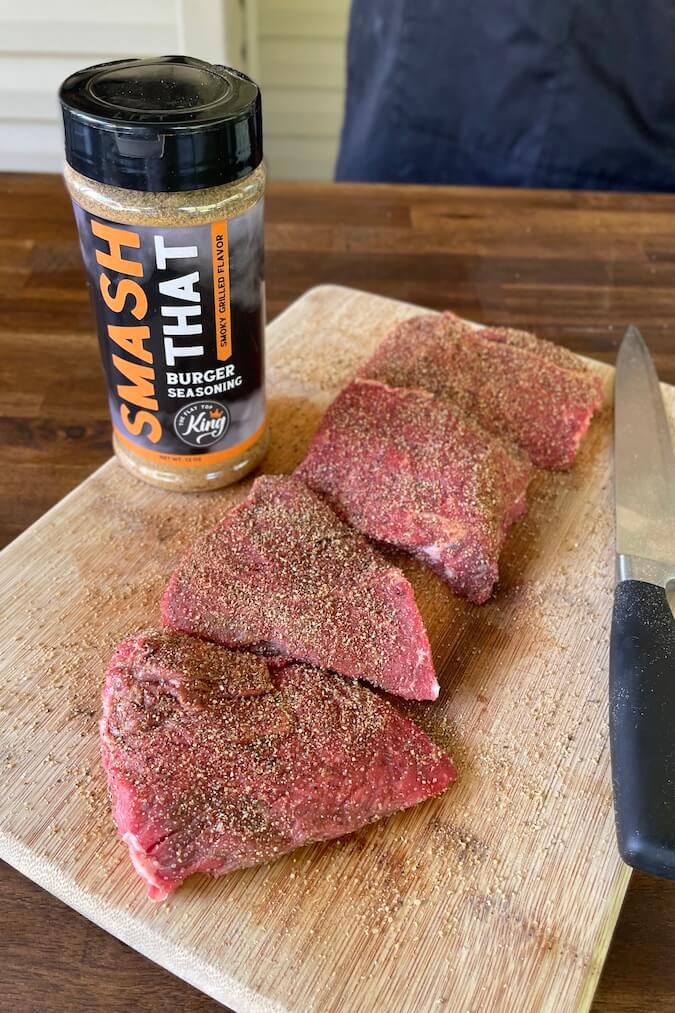 seasoned sirloin steak on a cutting board