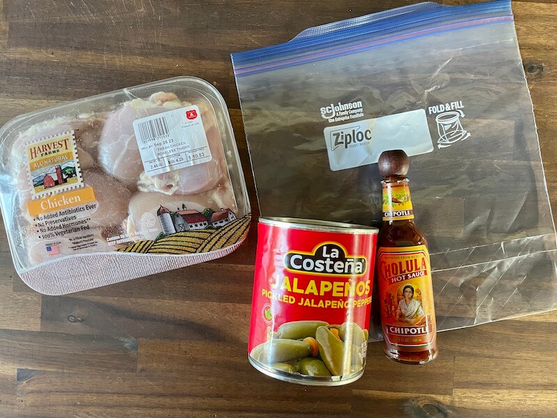 boneless skinless chicken thighs, canned jalapenos, hot sauce, and a ziploc bag