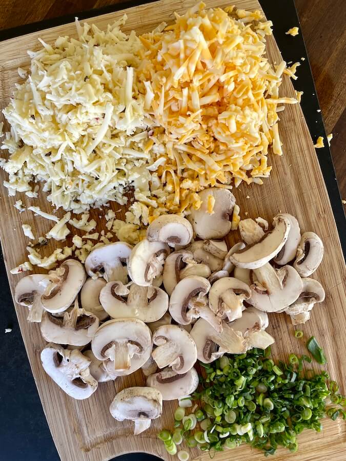 shredded cheese, sliced mushrooms, and green onion