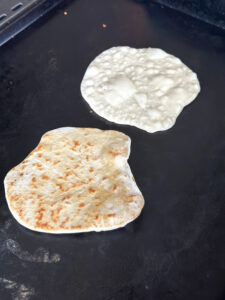 cooking naan bread on the griddle