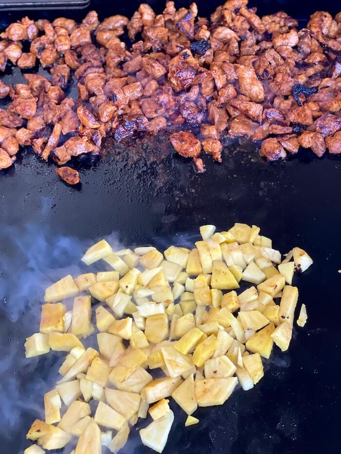 marinated pork and pineapple cooking on a griddle