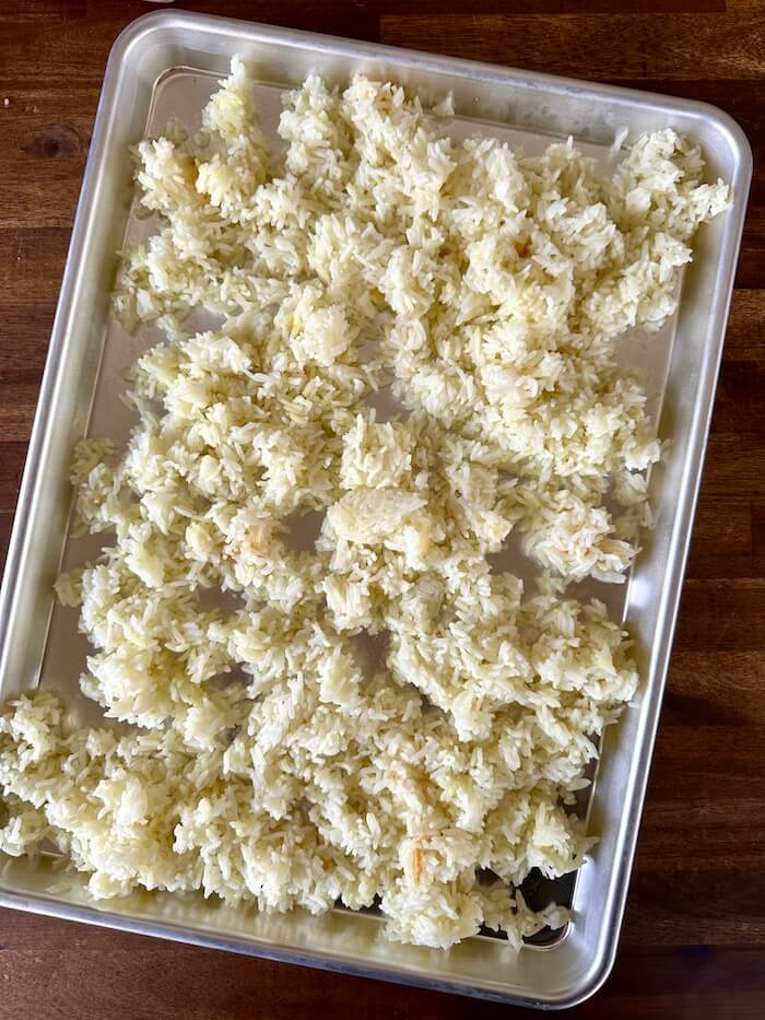 white rice cooling on a sheet tray