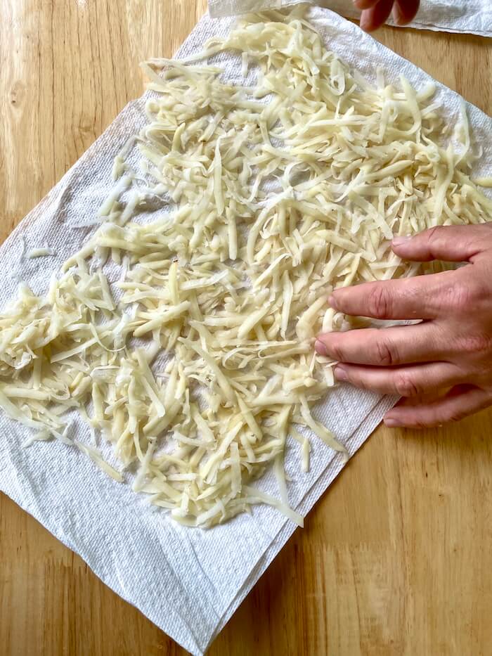 shredded potatoes drying on a paper towel