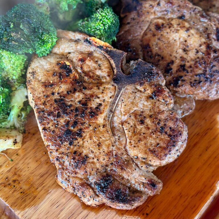 Blackstone pork chops resting on a cutting board