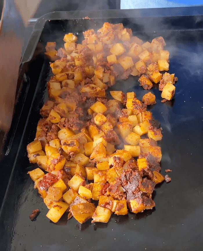 Mexican potatoes and chorizo cooking on the griddle