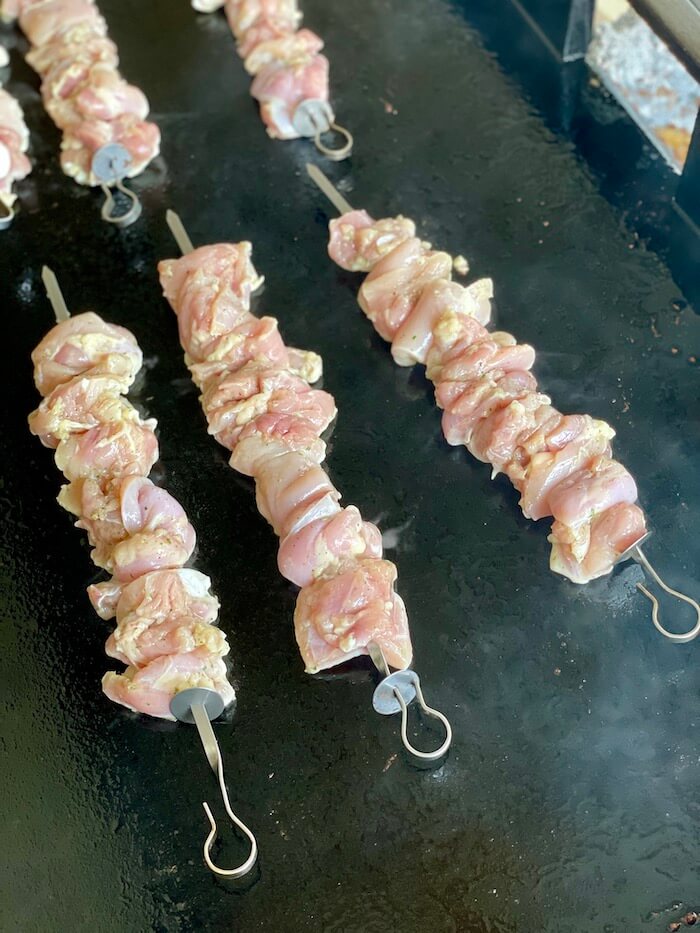 cooking chicken kabobs on a griddle
