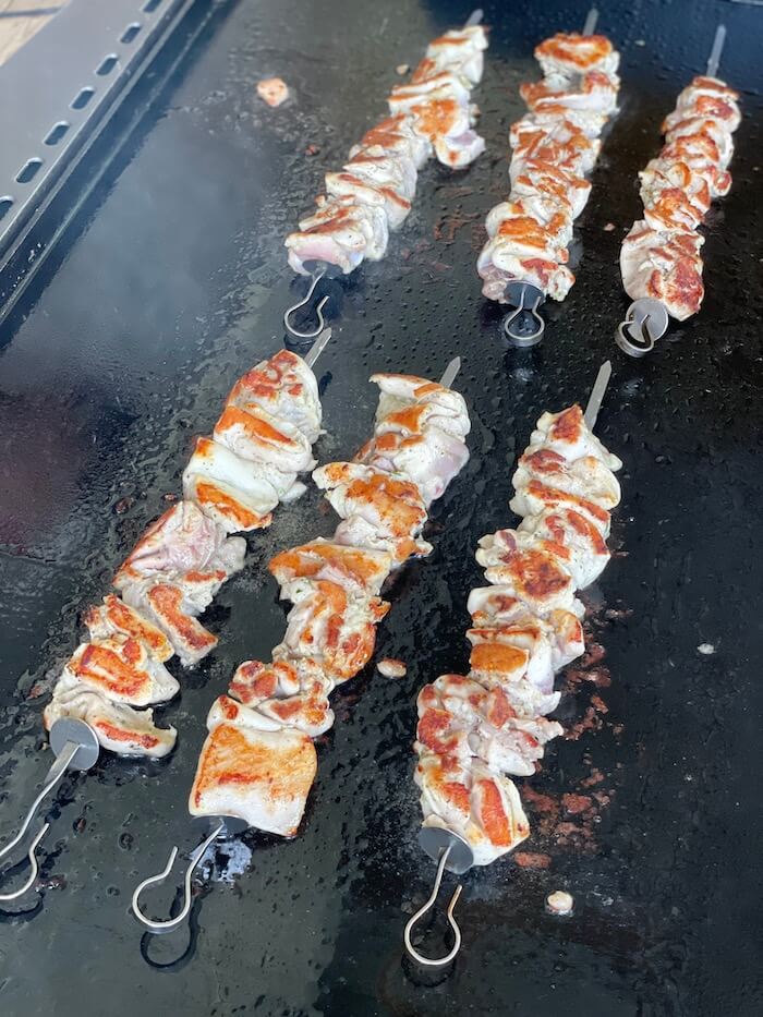 cooking chicken kabobs on the griddle