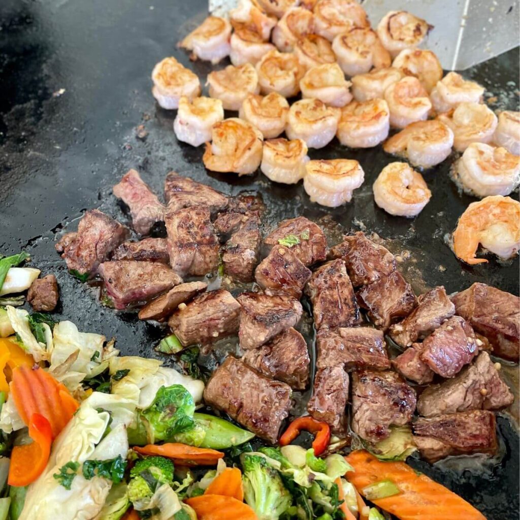 shrimp and steak stir fry on the griddle