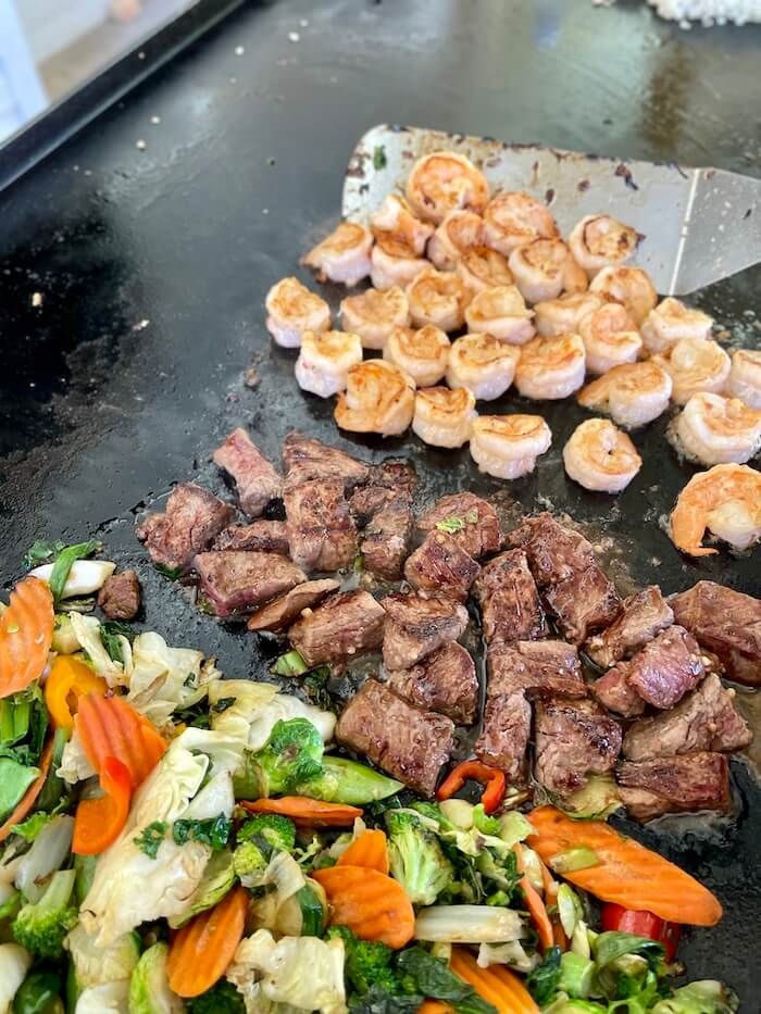 cooking stir fry on the Blackstone with shrimp and steak