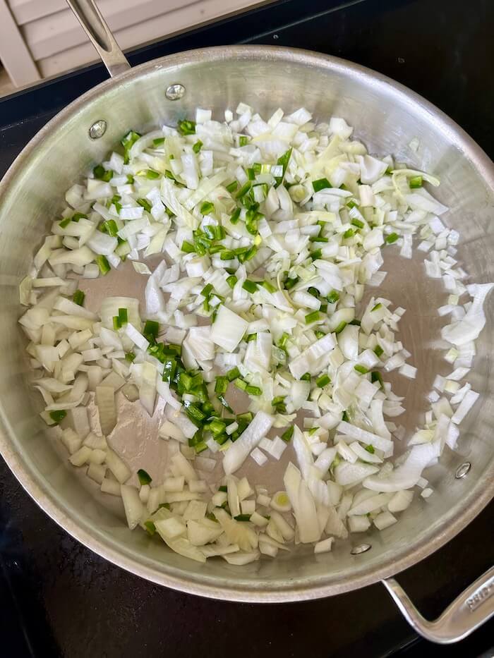 sautéing diced onions and jalapenos in a skillet
