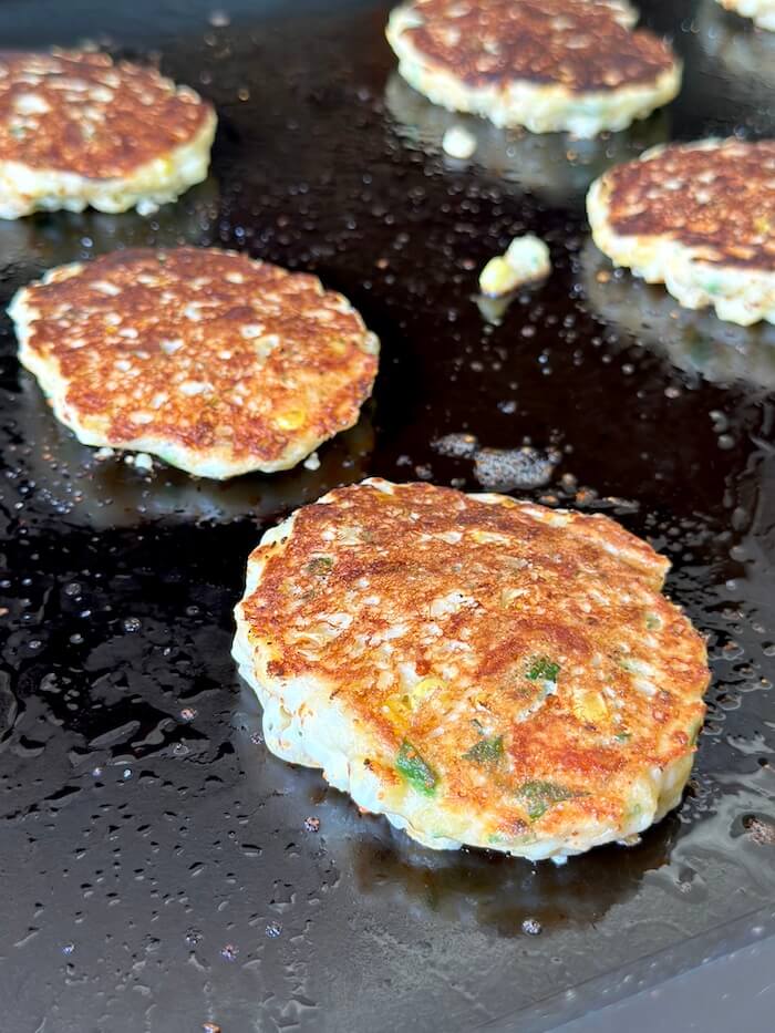 making Mexican corn fritters on a griddle