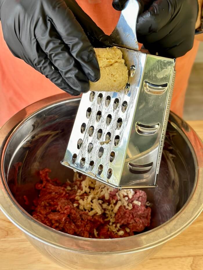 grating butter into raw ground beef