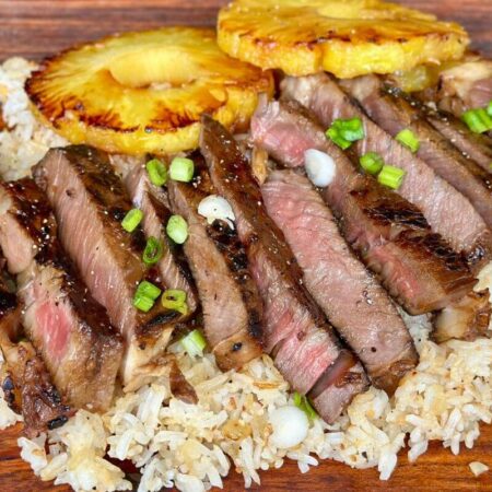 Hawaiian ribeye steak sliced and served over rice with grilled pineapple