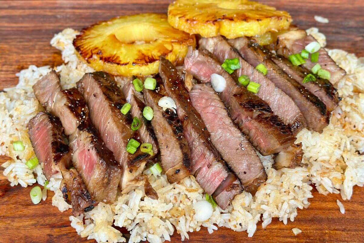 Hawaiian ribeye steak sliced and served over rice with grilled pineapple