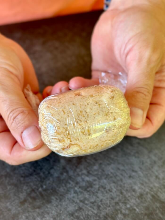 wrapping roasted garlic compound butter in plastic wrap
