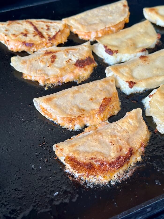 frying corn tortillas filled with Mexican mashed potatoes