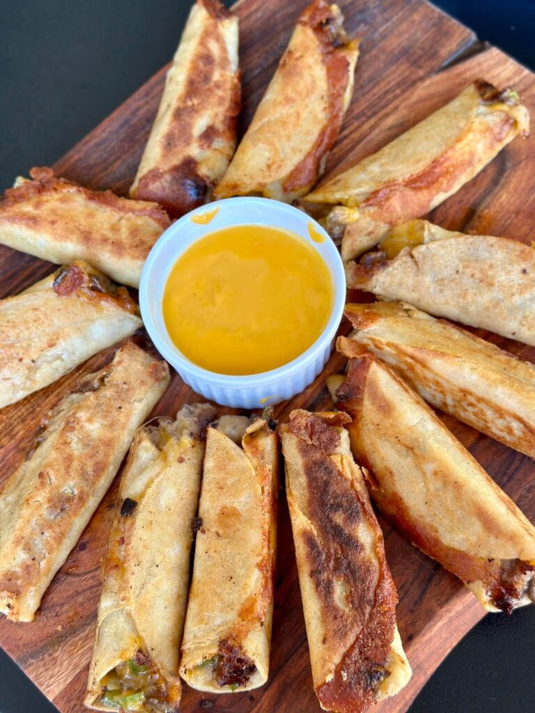 cheesesteak taquitos with cheese dip