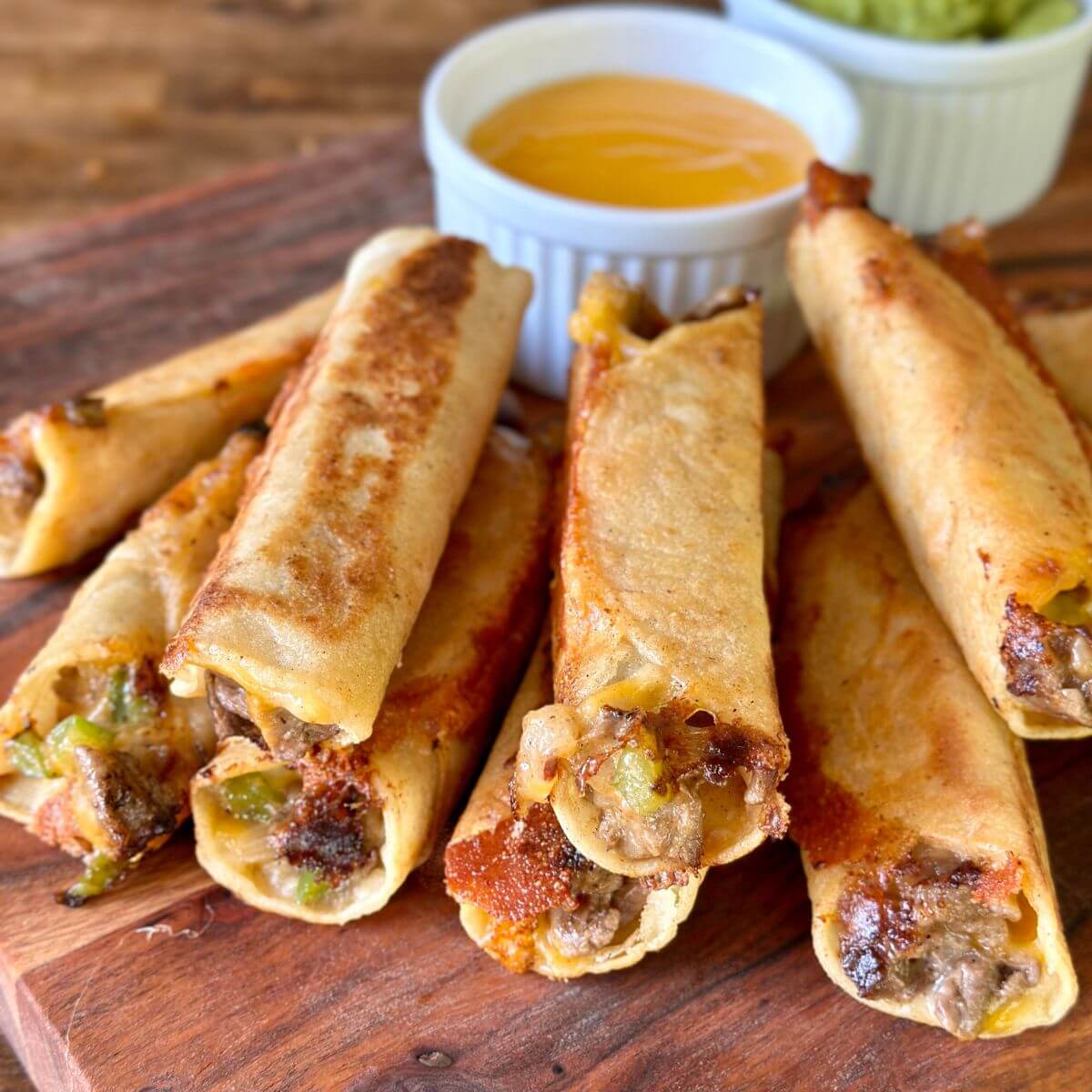 cheesesteak taquitos with cheese sauce