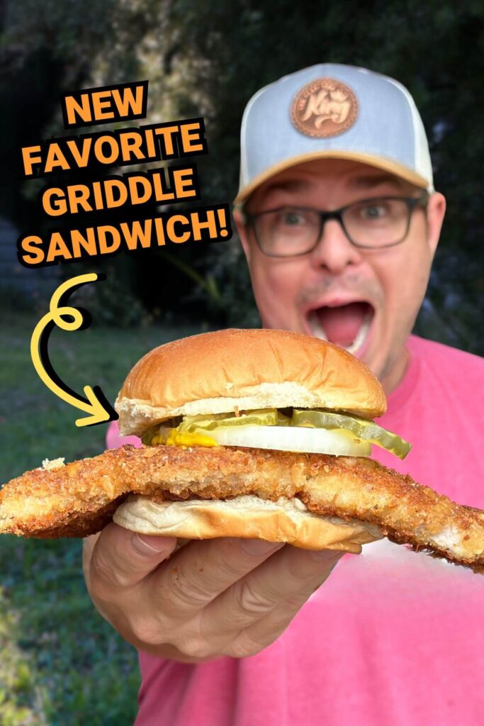 man holding a fried pork tenderloin sandwich