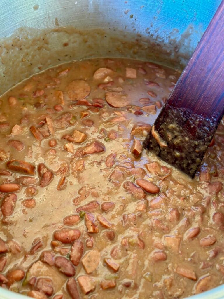 Cajun red beans and smoked sausage cooking in a pot