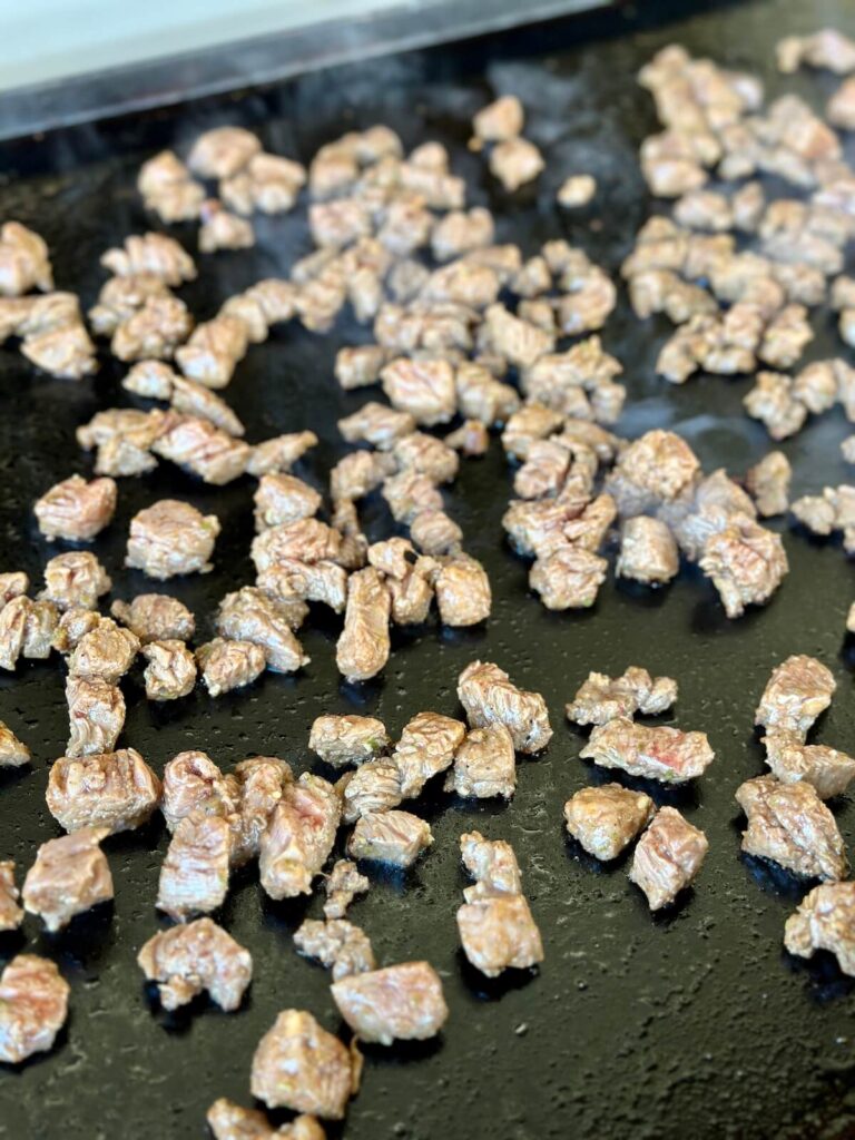 cooking carne asada on a Blackstone griddle