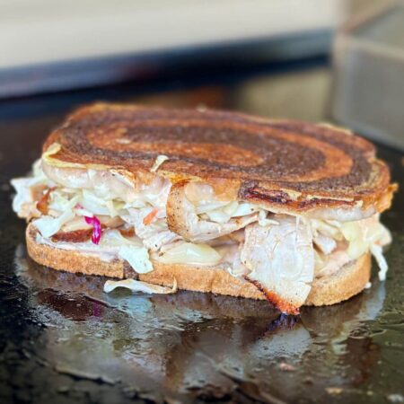 Rachel sandwich cooking on a griddle