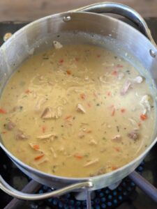 turkey and dumpling soup simmering in a pot