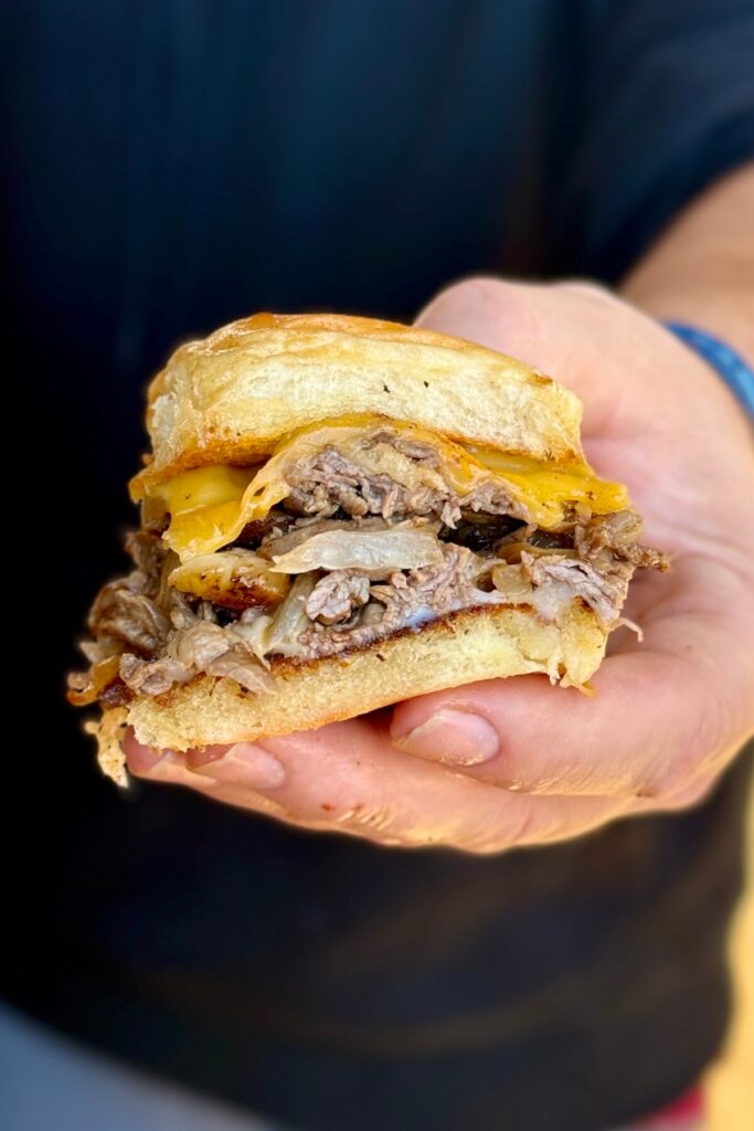 a cheesesteak slider with provolone cheese, American cheese, and King's Hawaiian roll