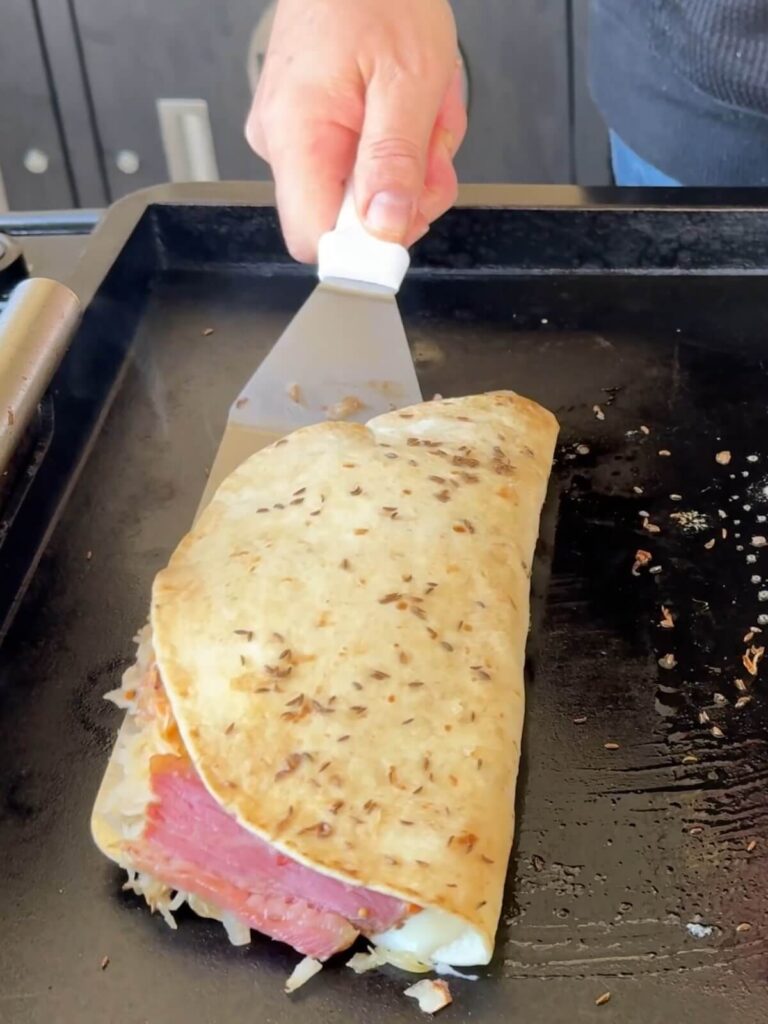 flipping a quesadilla on a griddle