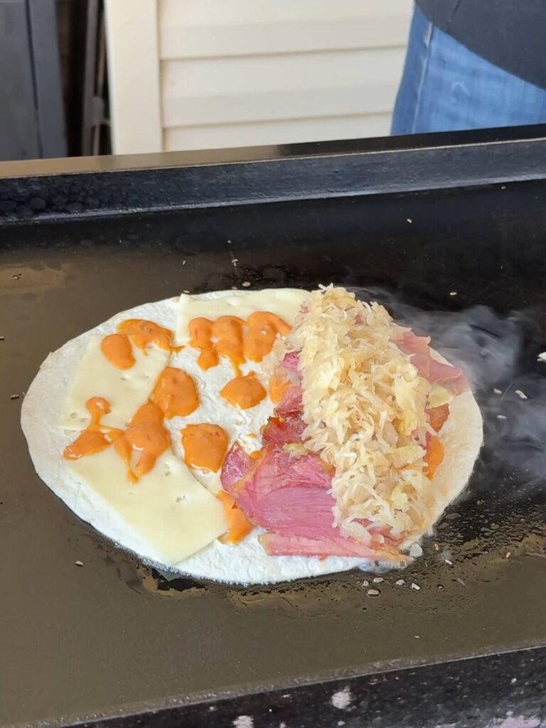 making a reuben quesadilla on a Blackstone griddle