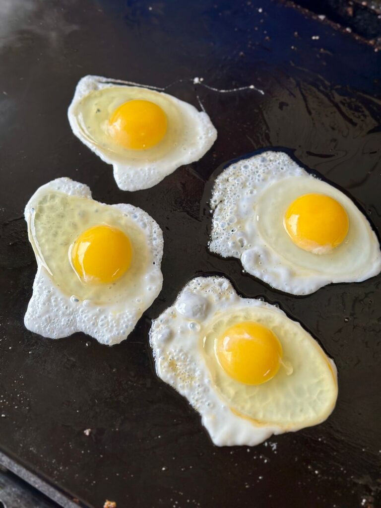 cooking over easy eggs on the blackstone griddle