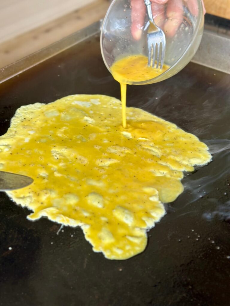 pouring eggs on a Blackstone griddle