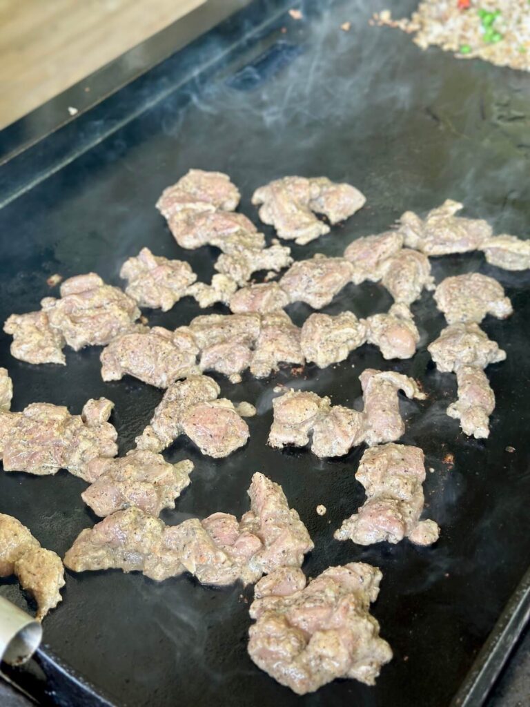 cooking Jamaican jerk marinated chicken on a griddle