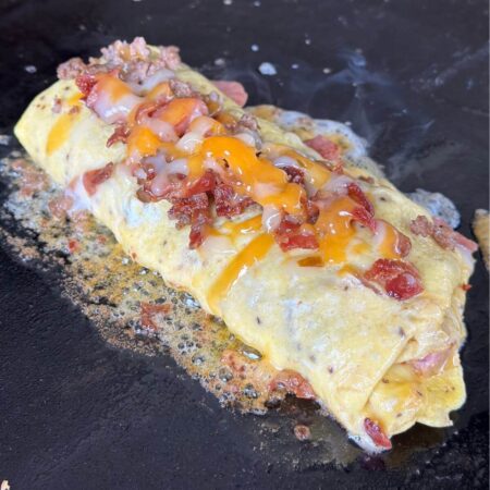 meat lover's omelette on a blackstone griddle