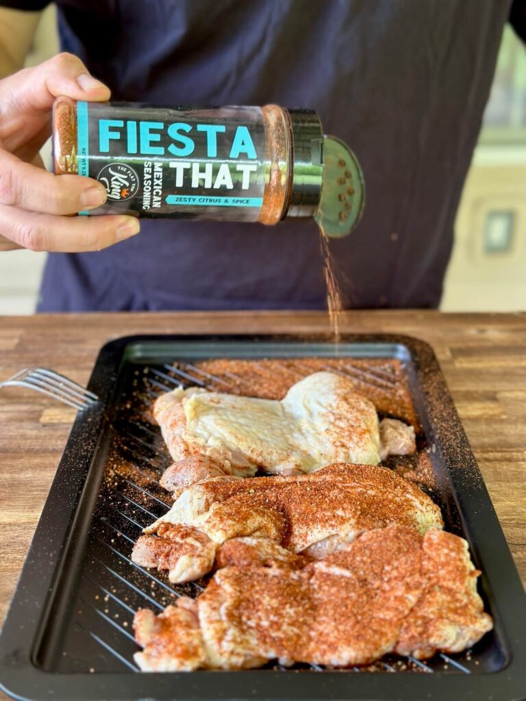 seasoning chicken with a Mexican seasoning
