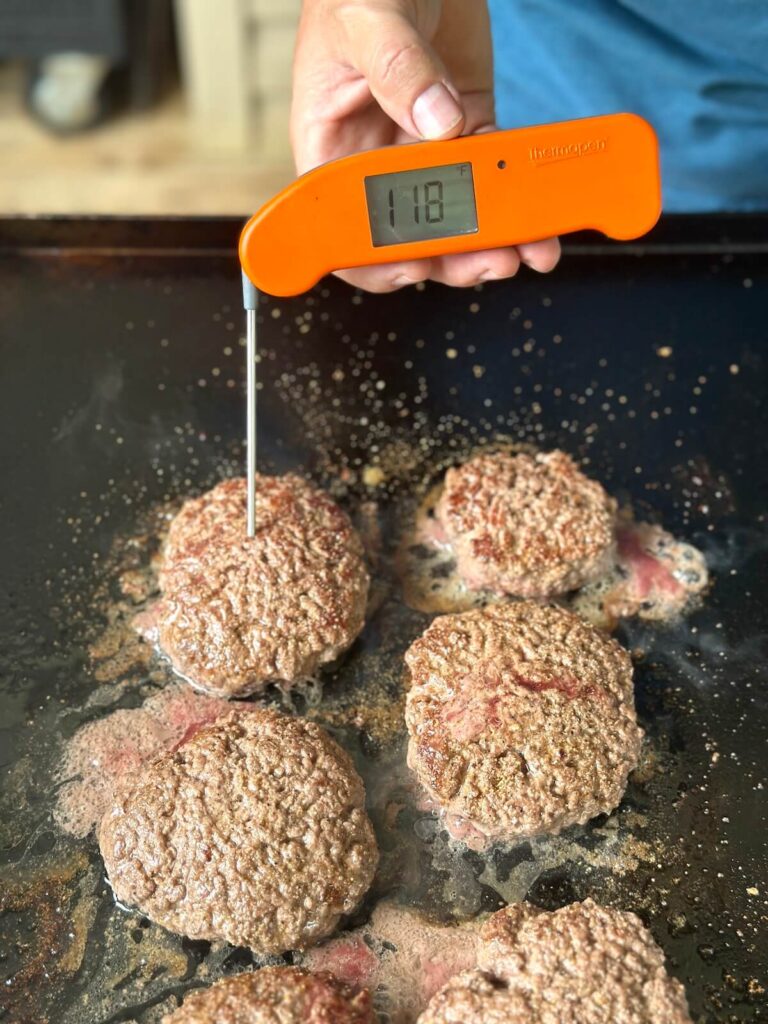 checking the internal temperature of burgers