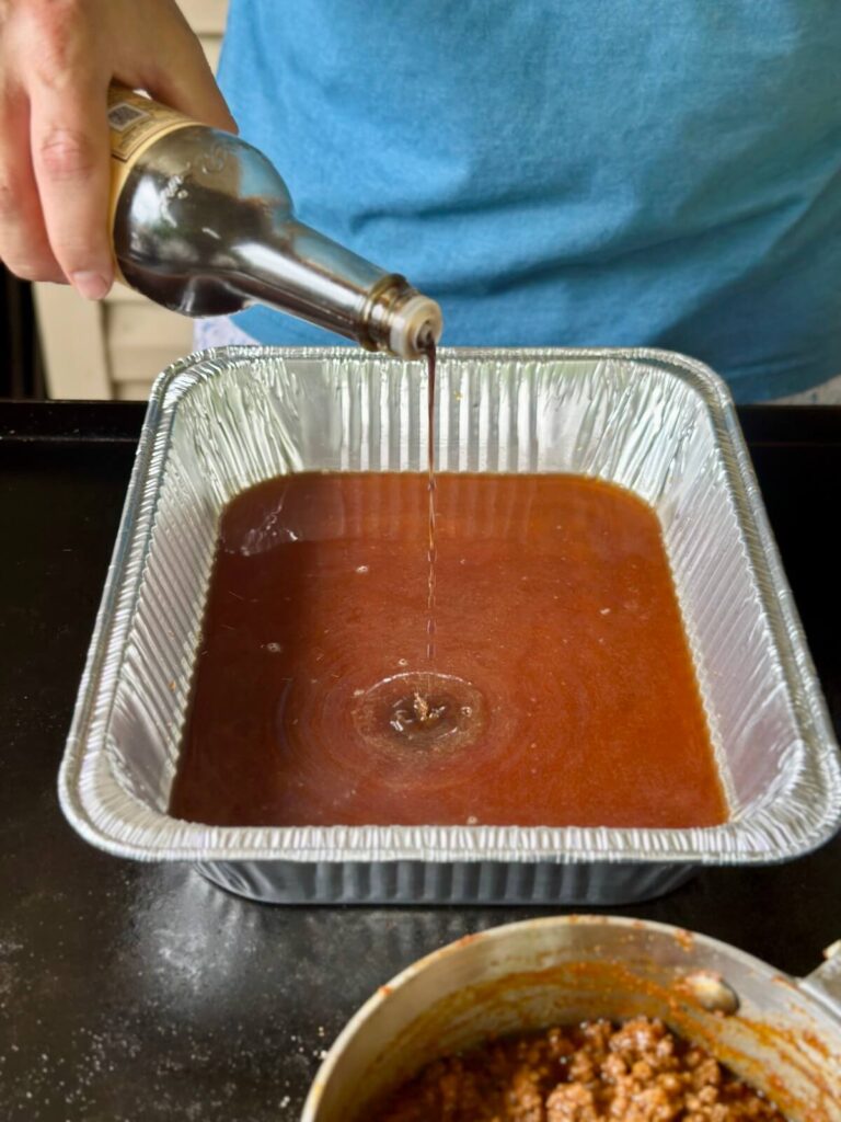 beef broth and Worcestershire sauce in an aluminum foil pan