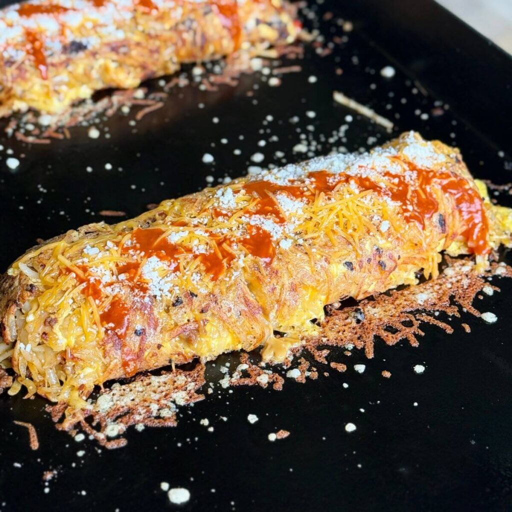 hash brown omelette with chorizo cooking on a Blackstone griddle