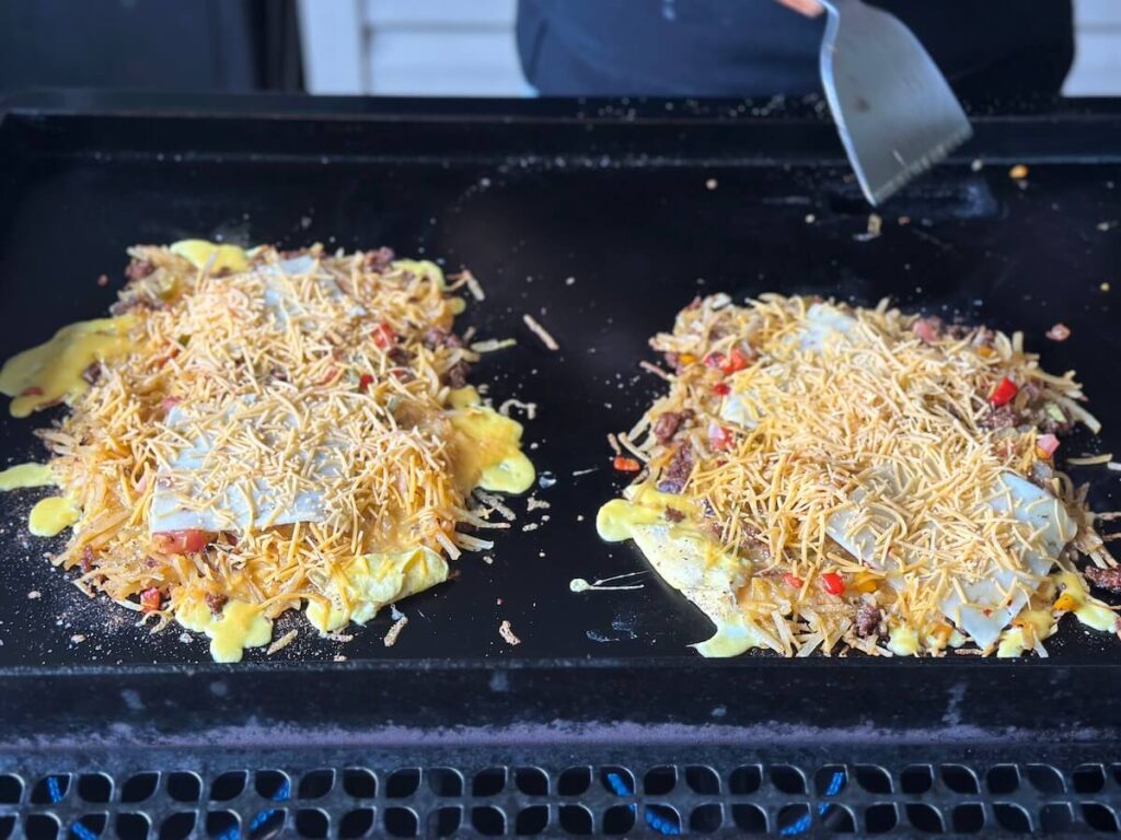 making two southwest hash brown omelettes on a griddle