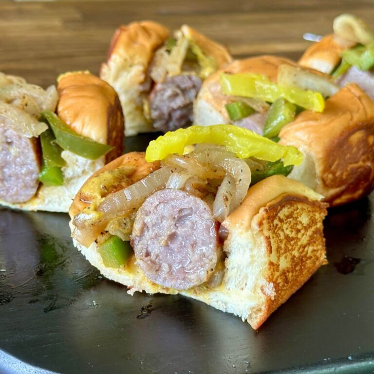 bratwurst sliders on King's Hawaiian buns with peppers and onions