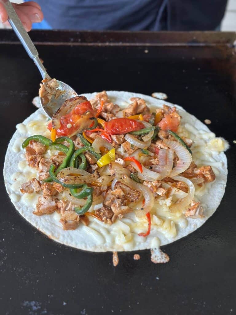 making a chicken fajita quesadilla on a griddle