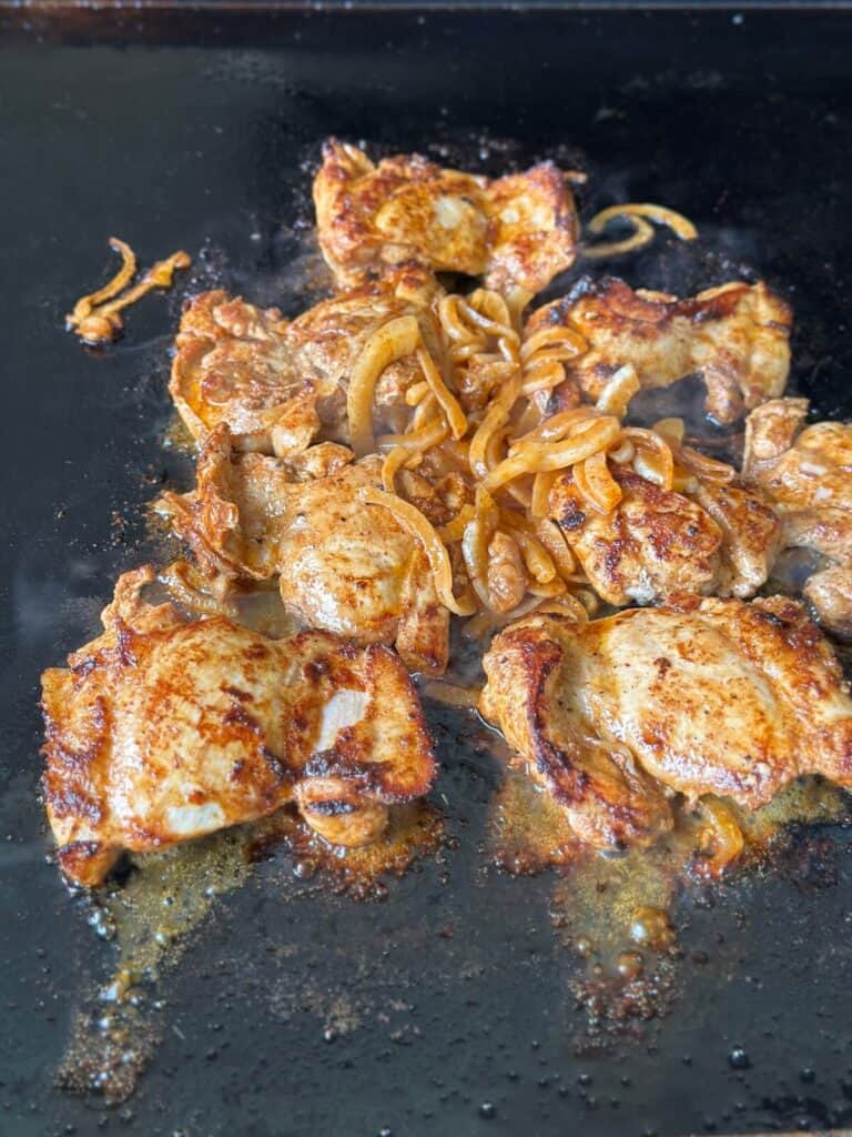 cooking Mexican marinated chicken on a griddle