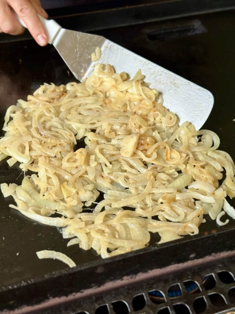 sautéing onions on a griddle